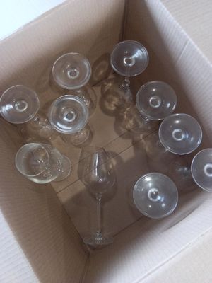 many empty wine glasses in a box on the floor