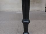 the base of a black table with a white top and black legs