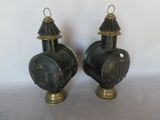 pair of black and gold vases sitting on top of a table