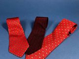 two red and black neck ties on a blue background