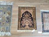 several rugs are laid out on the floor on a wooden floor