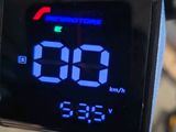 a digital clock on the handlebar of a bike