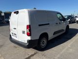 the back end of a white van parked in a parking lot