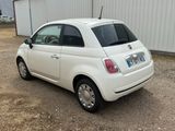 a small white car parked in front of a building