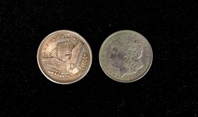 two coins are shown side by side on a black surface