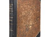an old book sitting on top of a table next to a white background