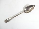 a silver spoon with a spoon handle on a white surface
