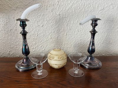 three wine glasses and a candle holder on a table