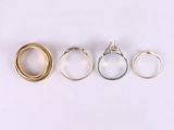 three different types of wedding rings on a white surface