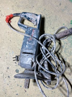 an old power cord and a cord cutter on the floor