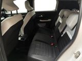 the back seats of a white car with black leather trims