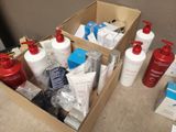 many bottles of lotion in a box on the floor