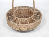 a wicker basket with a handle on a white surface
