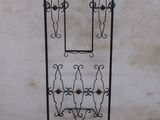a black iron rack with a mirror on it