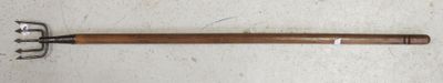 a wooden handle with a metal handle on a white surface