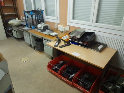 a desk with a lot of electronics on top of it