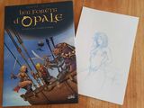 une photo d'un livre et un dessin représentant un pirate posés sur la table