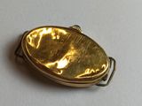 a gold locke with a picture on it on a white surface