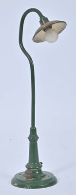 a green lamp that is on top of a green pole