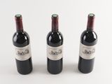 three bottles of wine sitting next to each other on a table