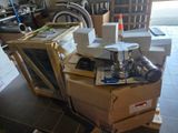 a pile of boxes and a laptop on the floor