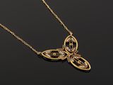 a gold necklace with a butterfly pendant on a black background