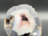 a close up of a piece of rock with a pink center