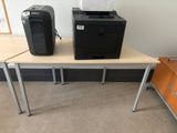 a printer and a printer on a table in a room