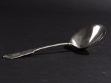 a spoon that is sitting on a black surface