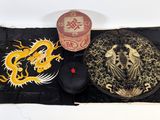 a hat and a mouse on a mat with a dragon on it