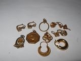 a lot of gold jewelry on a white surface