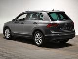 the back of a gray volkswagen suv parked on a checkered floor