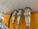 three cables connected to a white boat with a yellow background