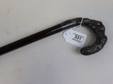 a black cane with a label on it on a table