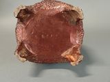 an image of a pink glass bowl on a gray surface