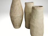 three vases sitting next to each other on a white surface
