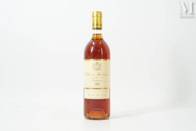 a bottle of wine sitting on top of a white table