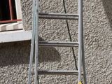 a ladder leaning up against a building next to a window