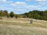 a man that is flying a kite in a field