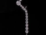 a close up of a diamond necklace on a black background