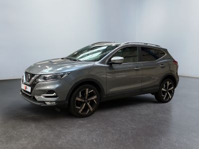 a grey nissan suv parked in a room with a white wall