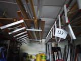 a picture of a garage with ladders and a sign