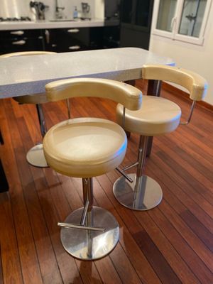 three stools that are sitting on a table in the kitchen