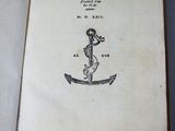 an open book with a drawing of a man on a boat