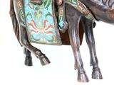 a statue of a horse with a saddle on it ' s back