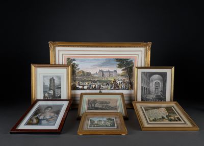 many framed pictures of different styles and sizes on the table