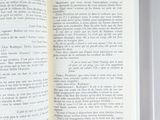 an open book sitting on top of a table next to a cup of coffee