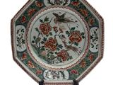 an image of a plate with a bird and flowers on it
