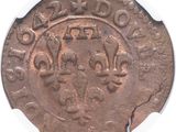 an old coin with a crown on it on a white surface