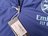 a close up of a blue jacket with a name tag on it